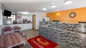 A modern kitchen with white cabinets, a microwave, and a coffee machine. - Econo Lodge Lithonia - Atlanta East (Lithonia)
