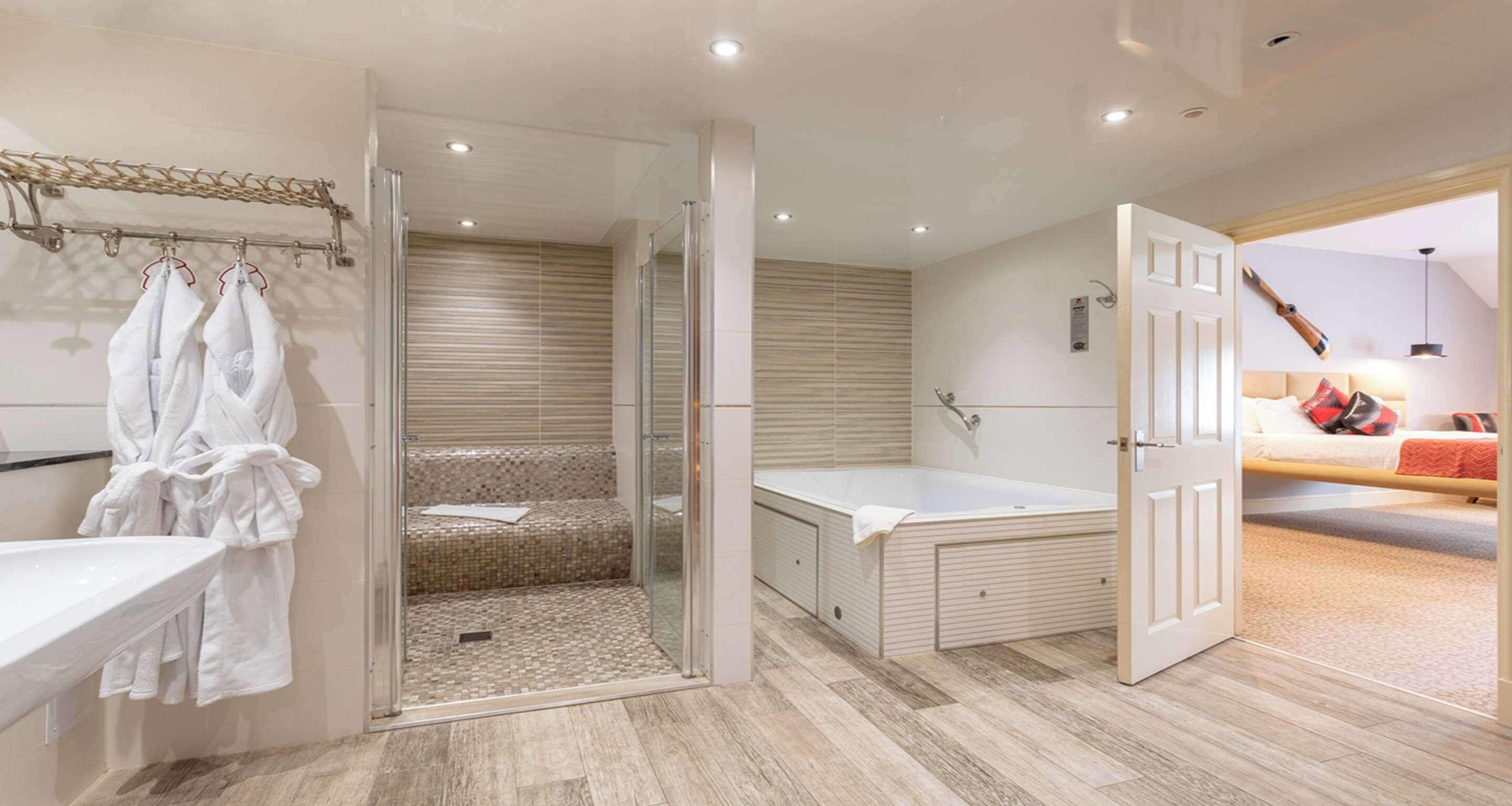 A modern bathroom with a glass-enclosed shower, a bathtub, and a walk-in shower.