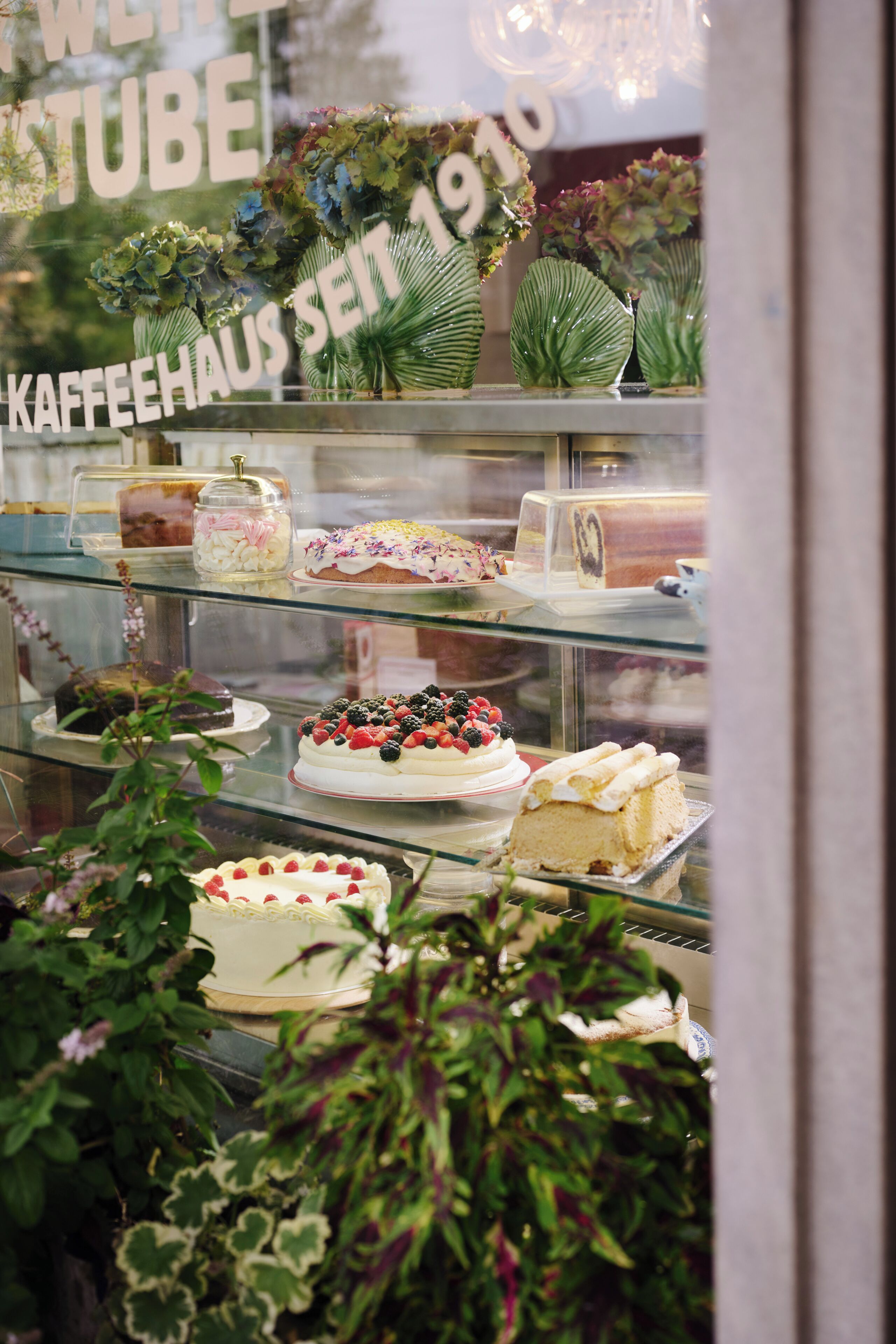 A bakery display case with various cakes and pastries.