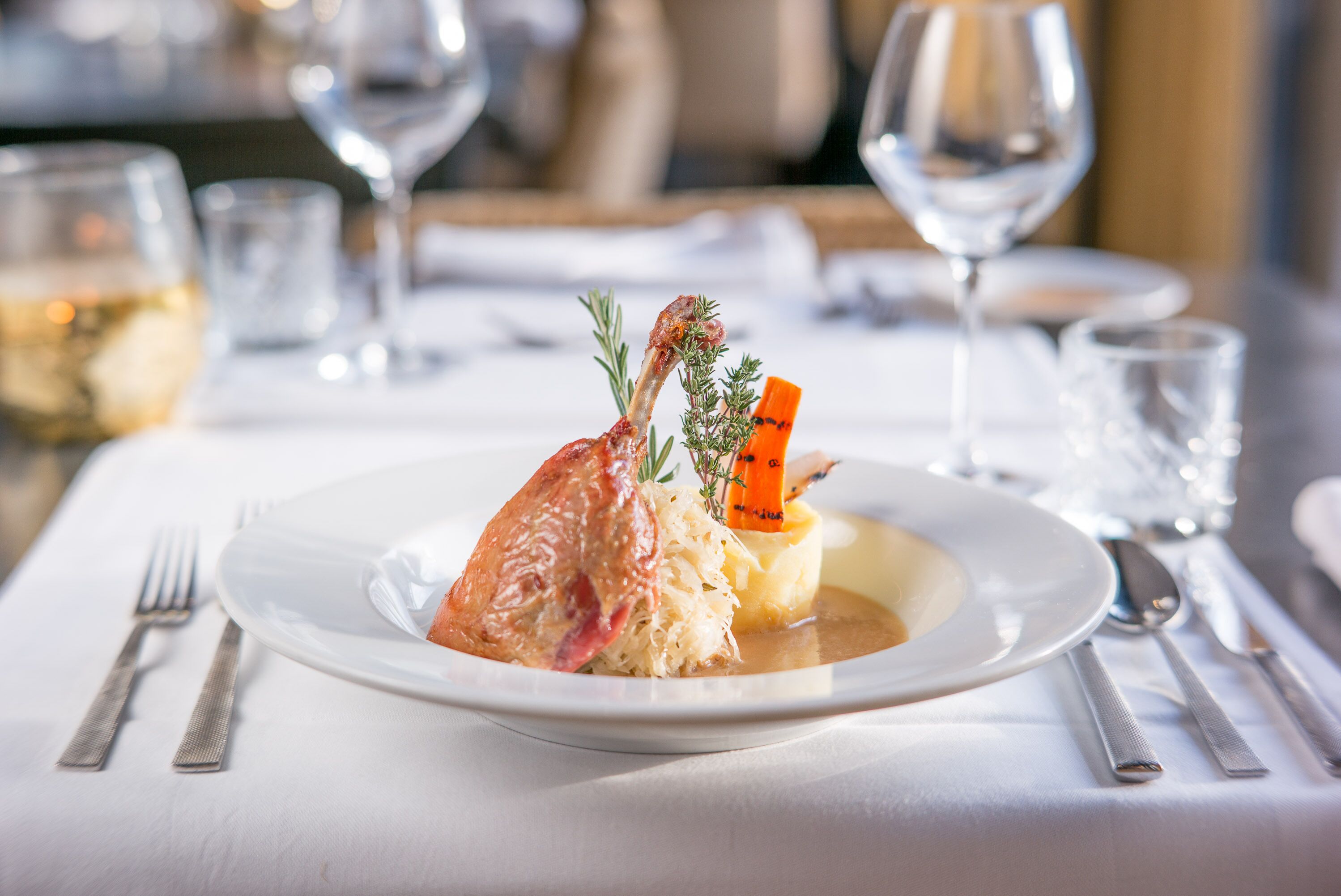 A plate of food with a fork and knife on a table.