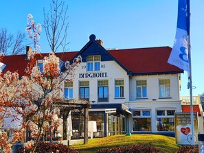 Berghotel features a two-story facade with a red-tiled roof and a well-manicured lawn.