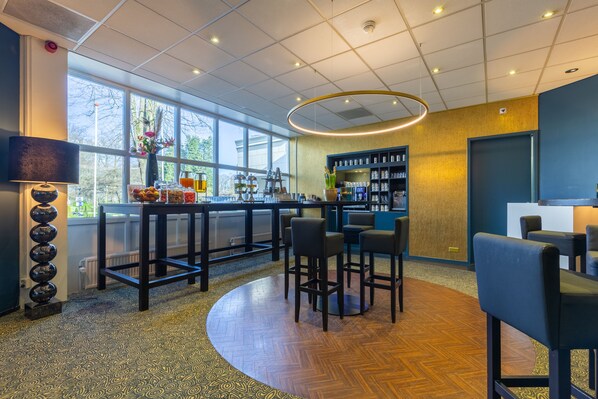Enjoy a drink at the bar, surrounded by a contemporary design and a view of the outdoors.
