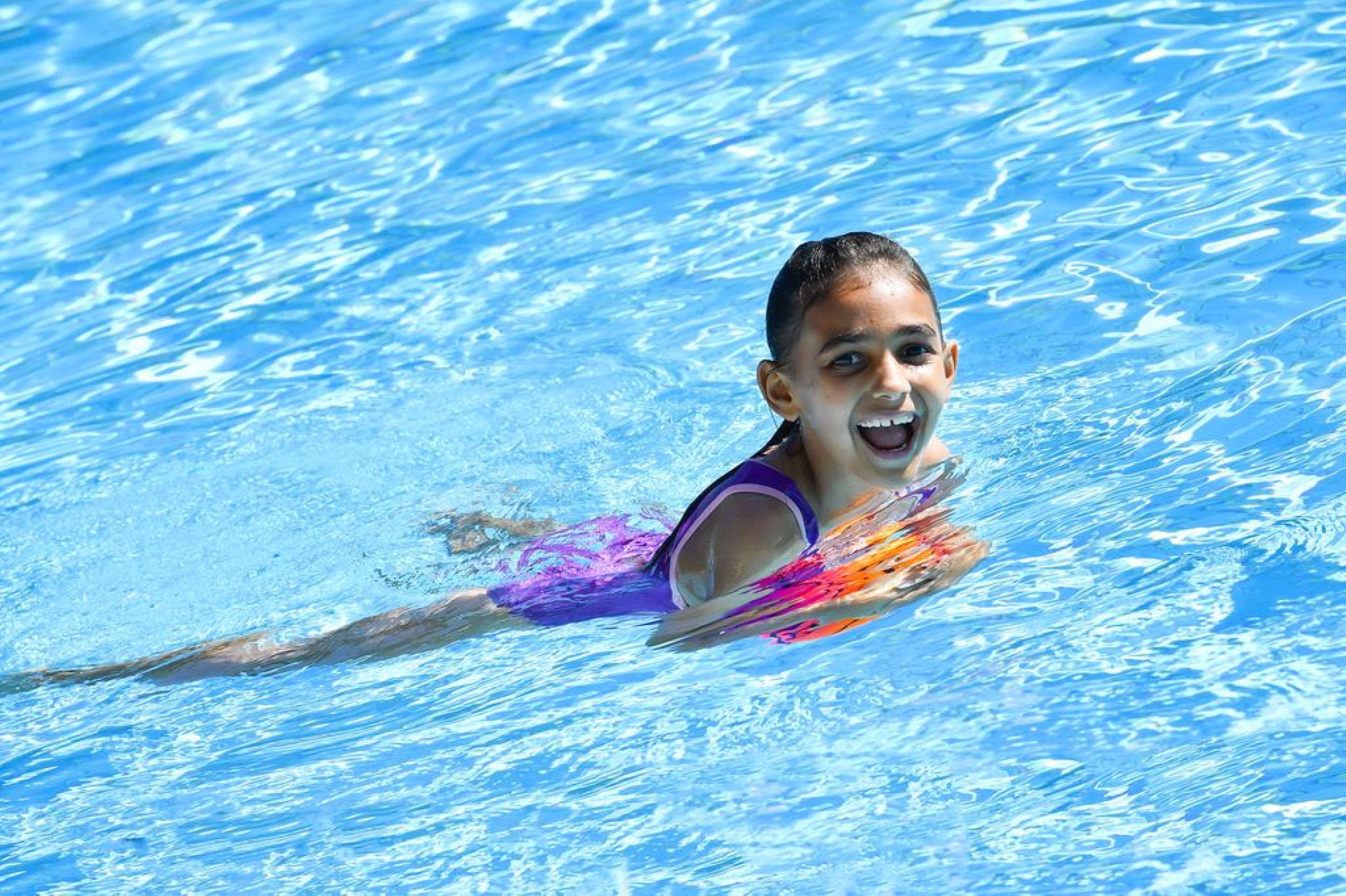 Una persona nadando en una piscina.