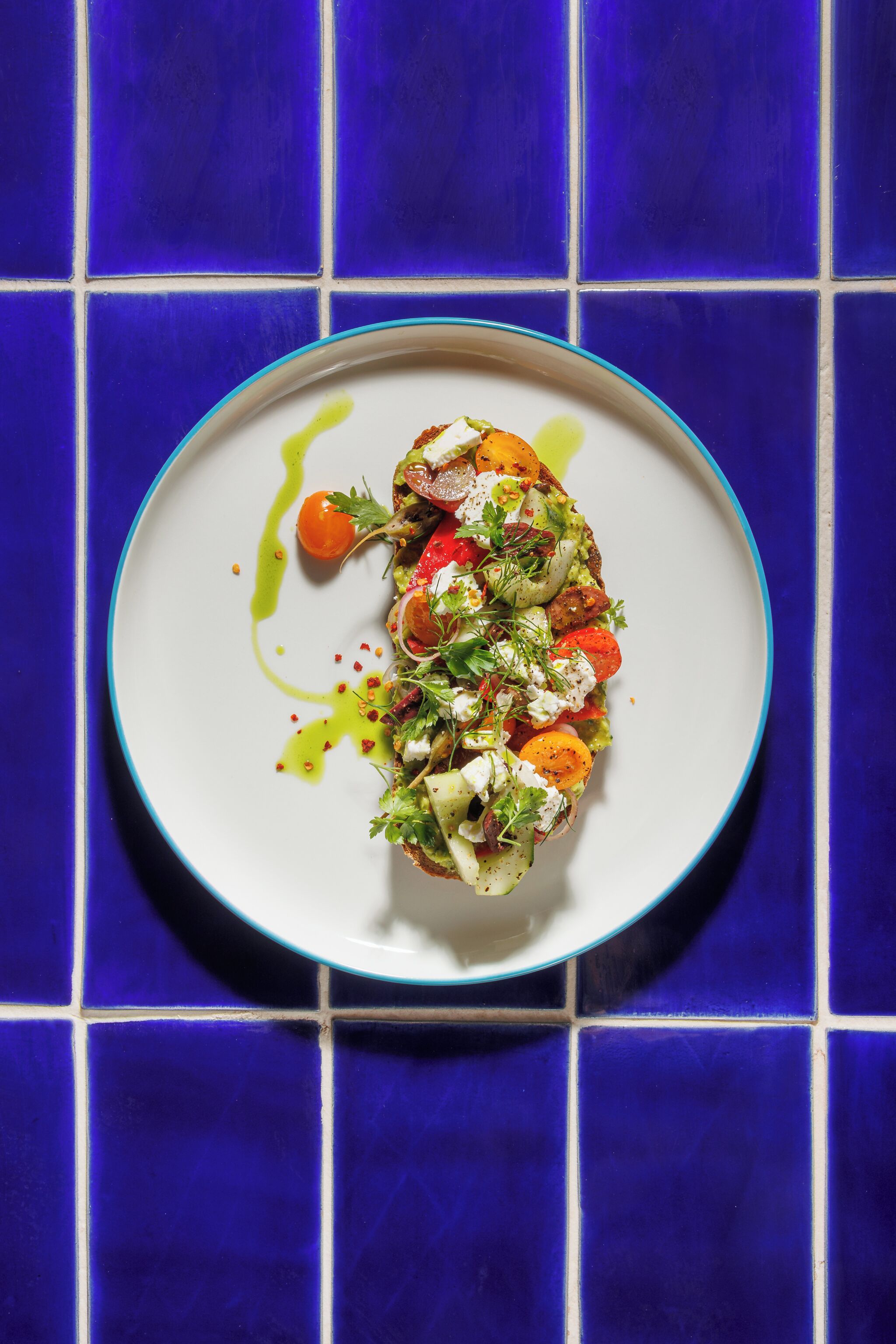 A plate of food on a blue-tiled surface.