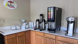 A kitchenette with a coffee machine, a water dispenser, and a wall-mounted coffee station. - Super 8 by Wyndham Lumberton NC (Lumberton)