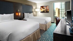 A hotel room with two beds, a desk, a chair, a lamp, and a painting on the wall. - DoubleTree by Hilton Hotel Arlington DFW South (Arlington)