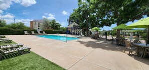 Seasonal outdoor pool, open 9 AM to 10 PM, pool umbrellas