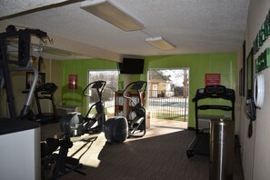 A gym with exercise equipment, a treadmill, and a mirror. - Quality Inn and Suites Garden of the Gods (Colorado Springs)