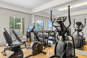 A gym with cardio machines, weight benches, and dumbbells. - Quality Inn at Albany Mall (Albany)