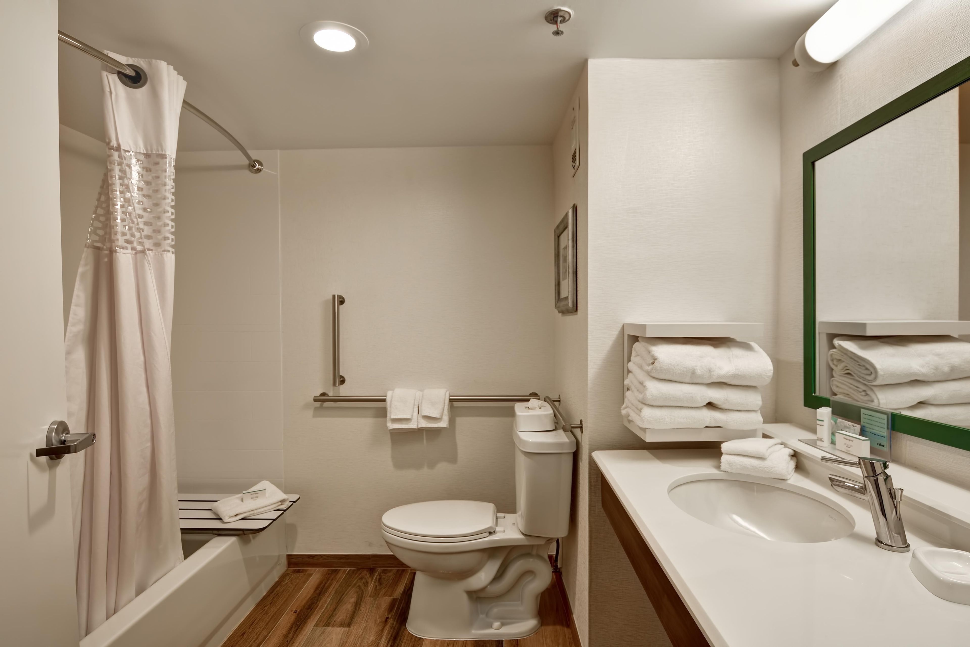 A bathroom with a shower, toilet, and sink.