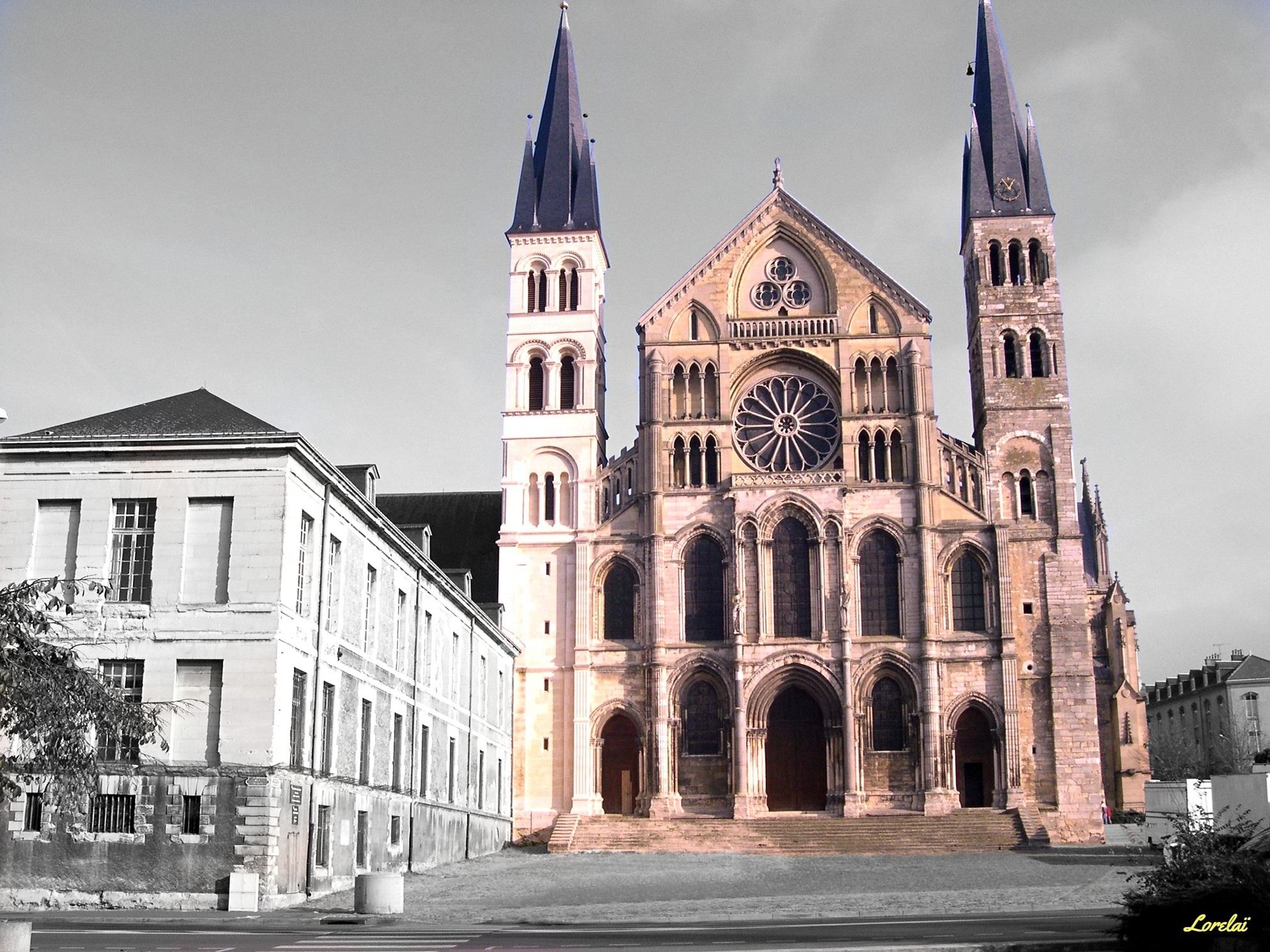 A large Gothic-style church with two tall spires, a large rose window, and a clock.