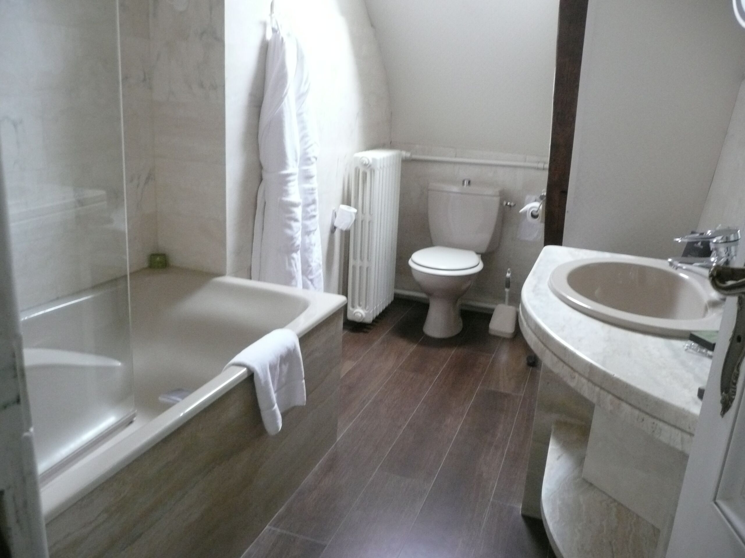 A bathroom with a bathtub, toilet, and sink.
