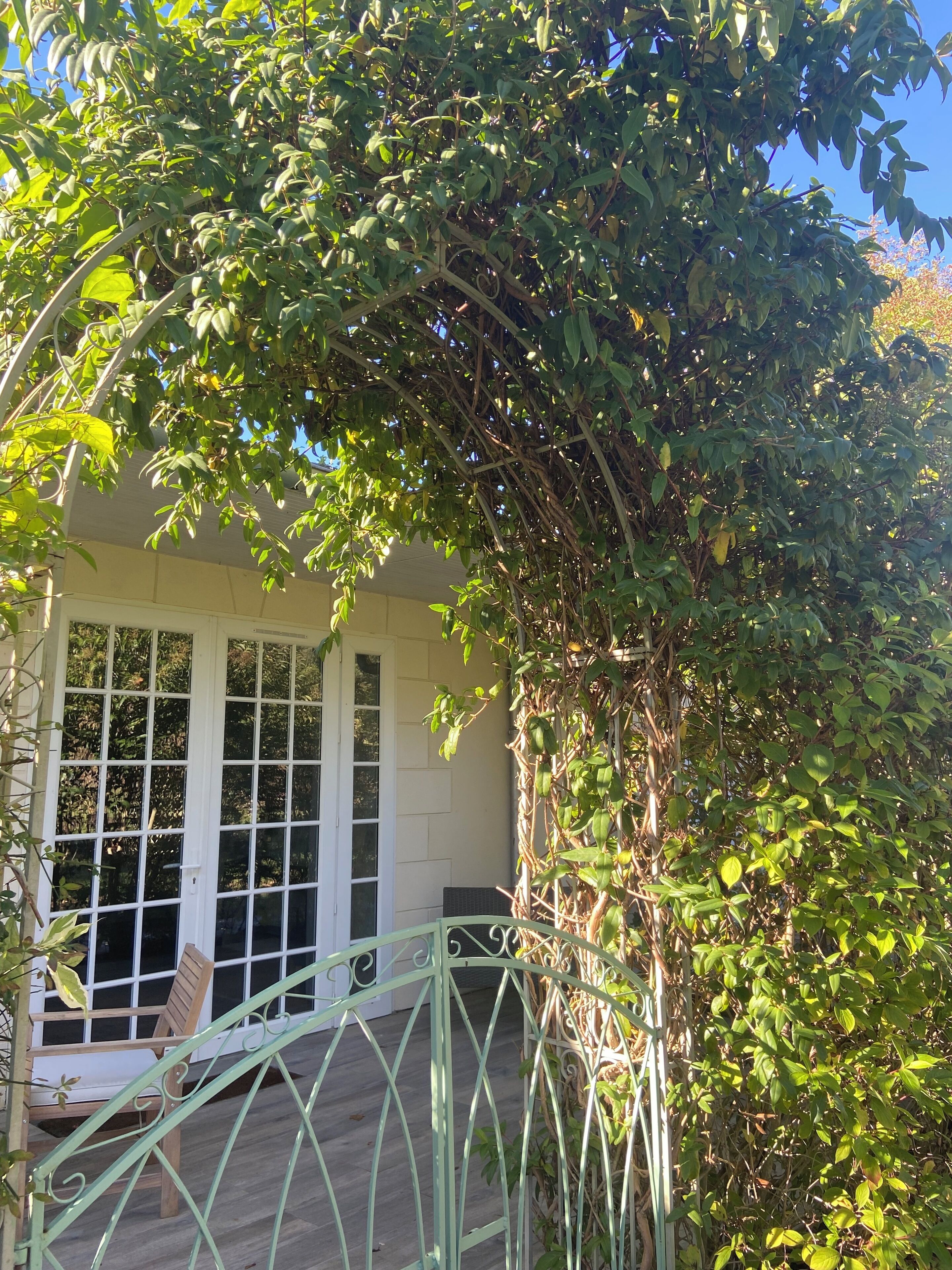 Un espacio al aire libre cubierto con un banco de madera y una barandilla de metal.