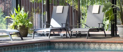 Indoor pool, open 6:00 AM to 10:00 PM, pool loungers