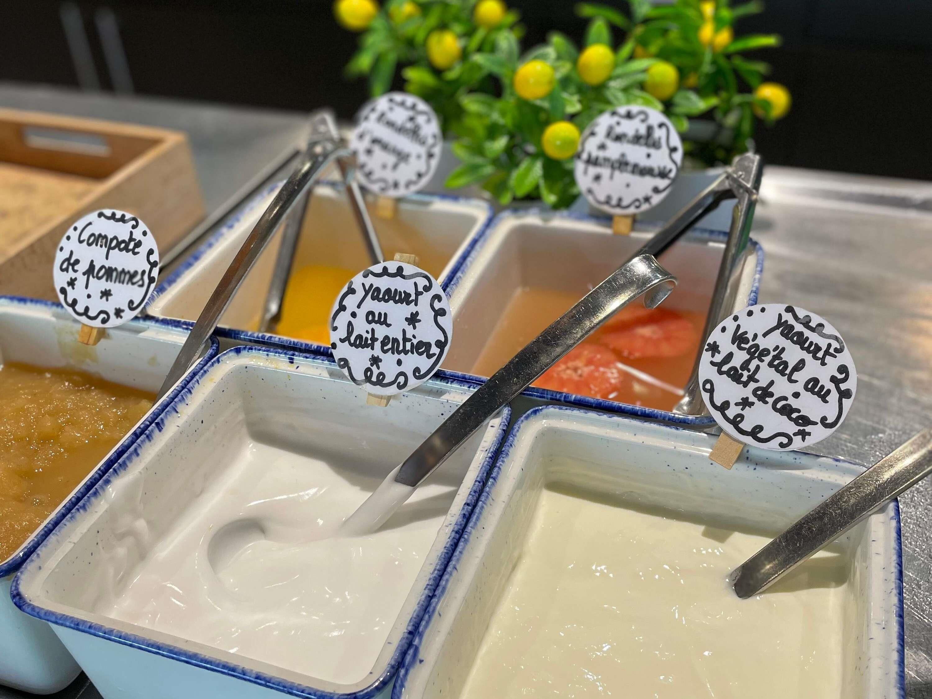 A variety of food items in containers with spoons, each labeled with different text.