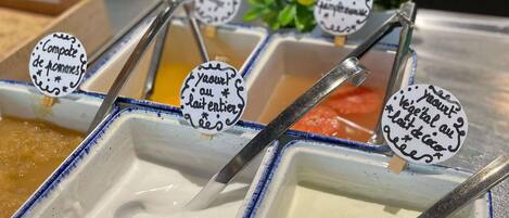 A variety of food items in containers with spoons, each labeled with different text.