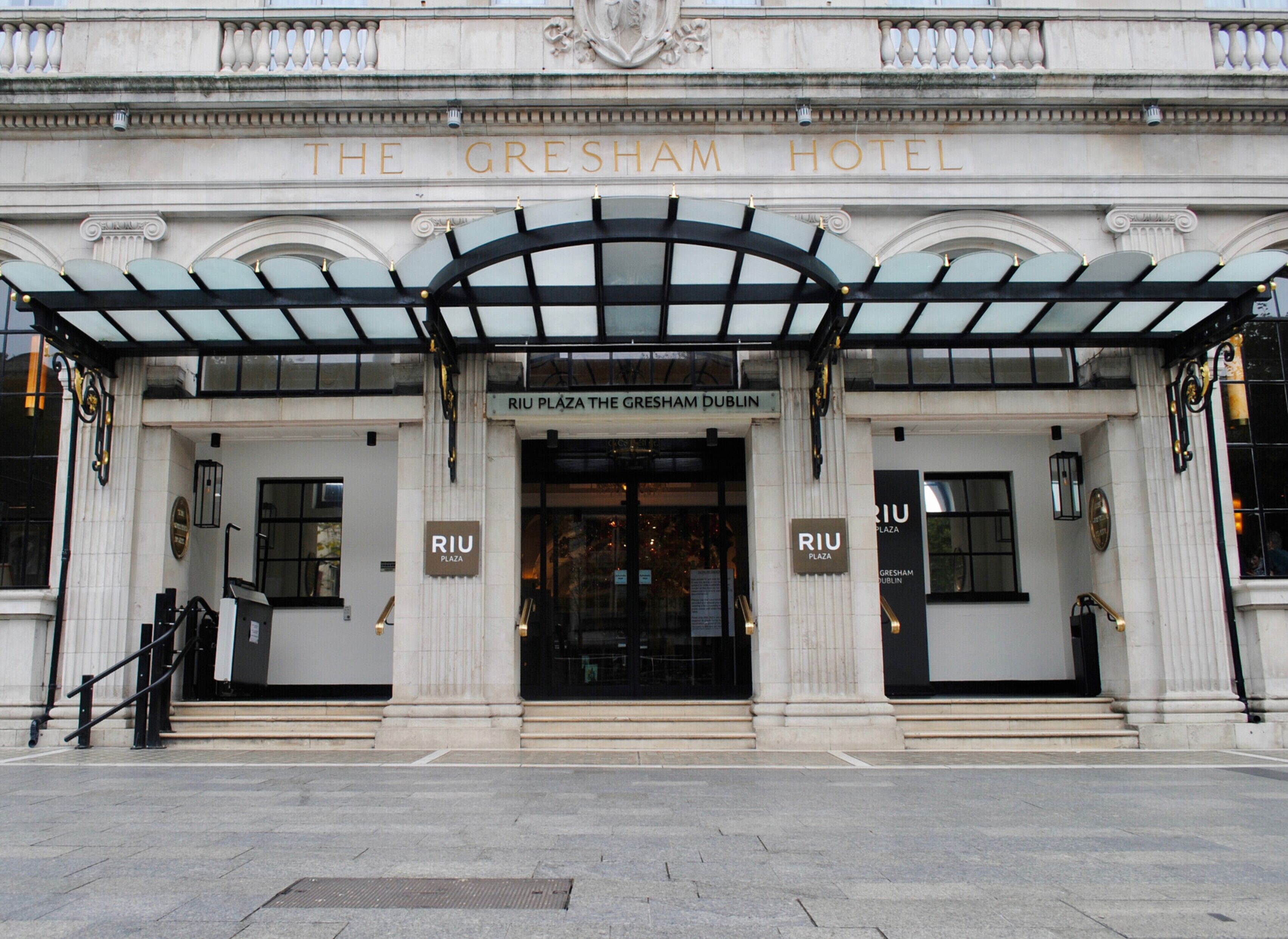 The Gresham Hotel entrance with classical architecture, including columns and a grand entrance.