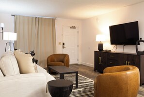 Executive Suite | Living room | 55-inch TV with cable channels, DVD player