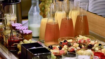 A buffet with various food items and beverages.