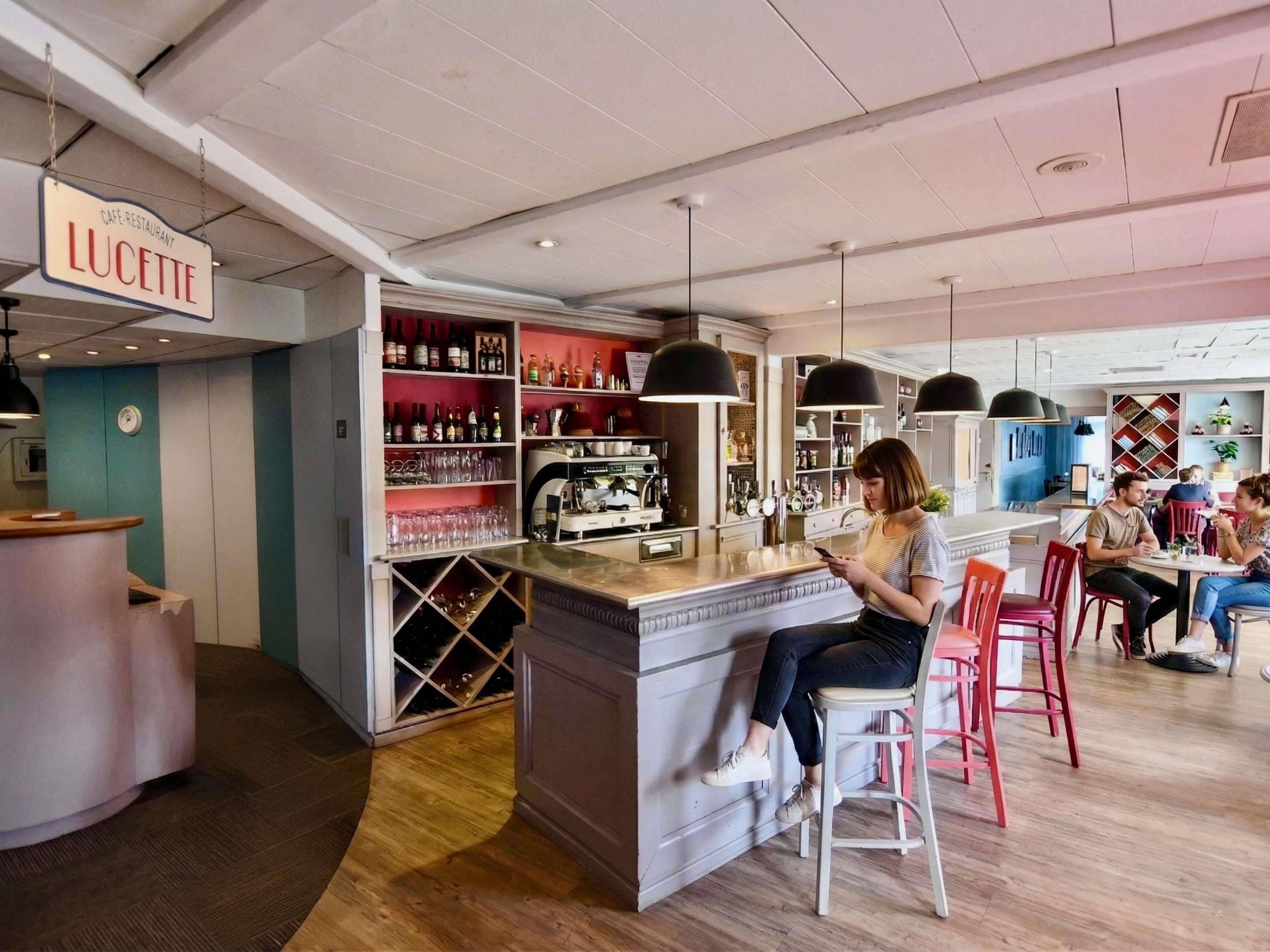 A cafe with a bar area, seating, and a counter with a sign reading 'LUCKETTE'.