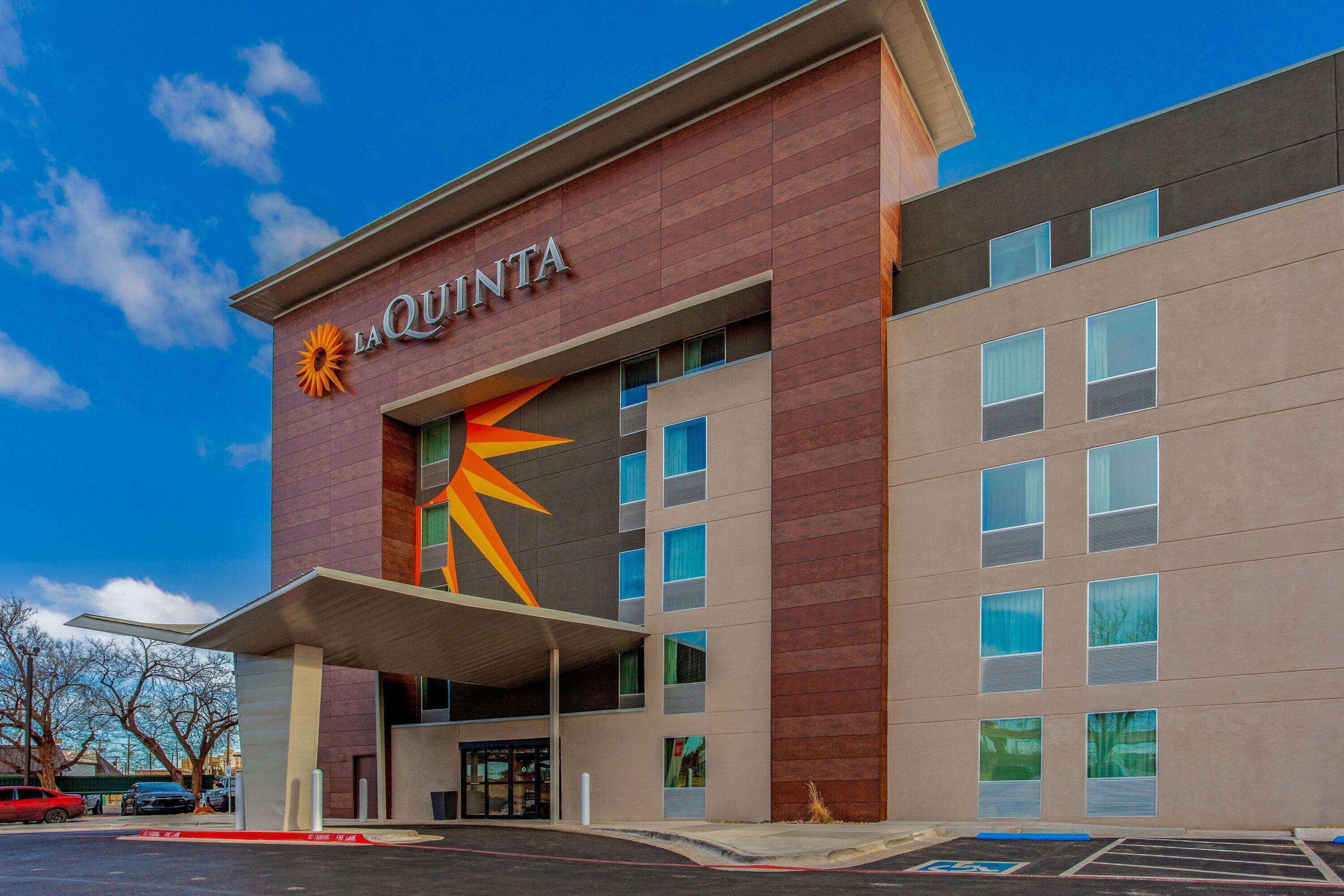 A hotel with a prominent logo and a modern facade.