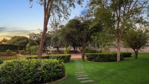 A well-maintained garden with a stone pathway leading to a building. - Park Hotel Mokopane (Mogalakwena)