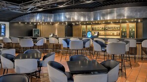 A modern bar area with seating and a bar counter. - Park Hotel Mokopane (Mogalakwena)