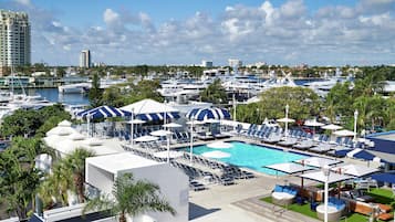 A marina with boats, a swimming pool, and lounge chairs.