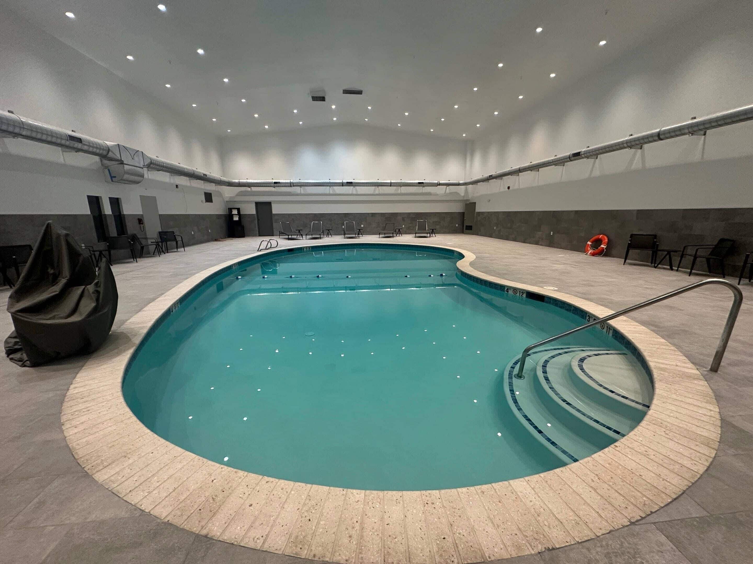 Indoor pool, open 8:00 AM to 10:00 PM, pool loungers