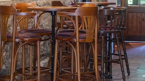A rustic interior with wooden furniture, stone walls, and stained glass windows. - Orton Hall Hotel & Spa (Peterborough)