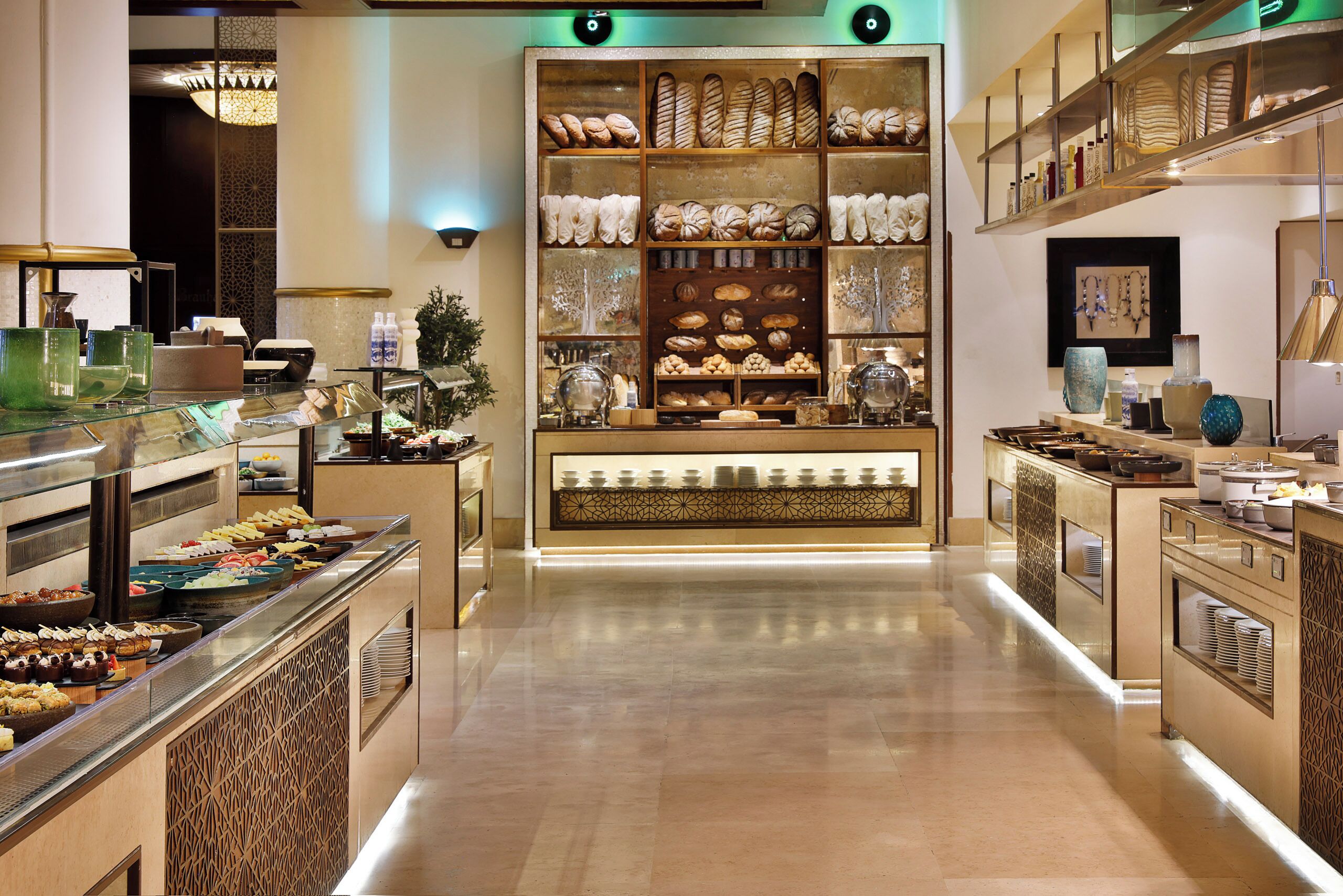 A buffet area with various food items and a display of baked goods.