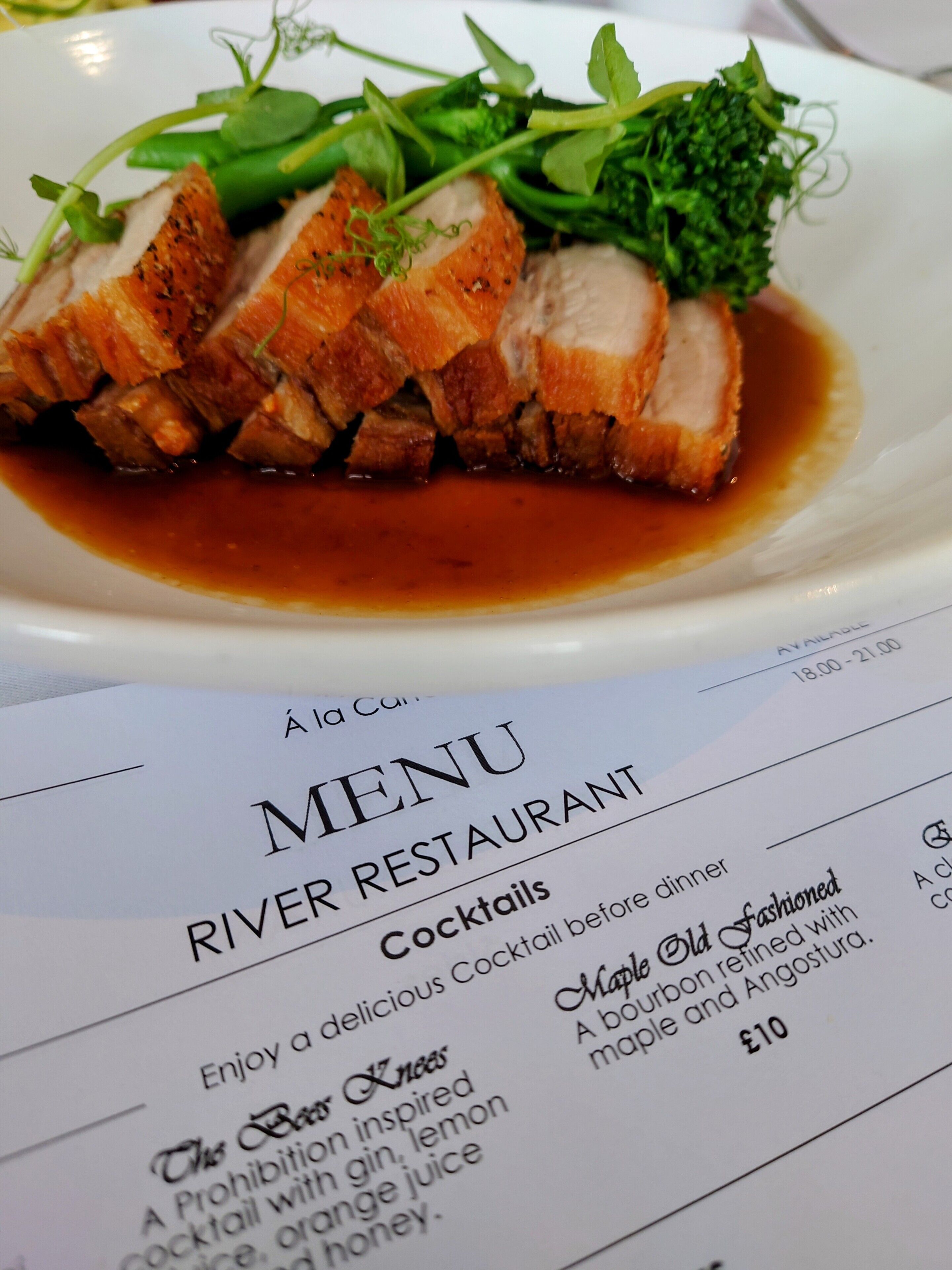 A menu from a restaurant with a dish of sliced meat and vegetables.
