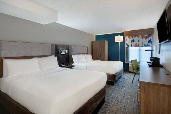 A hotel room with two beds, a desk, a chair, a TV, and a patterned wall. - Holiday Inn Express Rochester - University Area by IHG (Rochester)