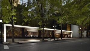 A modern hotel facade with large windows and a prominent 'OMNI Hotel' sign.