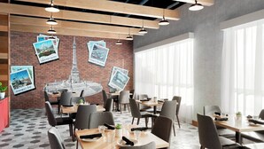 A modern dining area with hexagonal patterned flooring, wooden tables, and grey upholstered chairs. - Delta Hotels by Marriott Indianapolis Airport (Indianapolis)