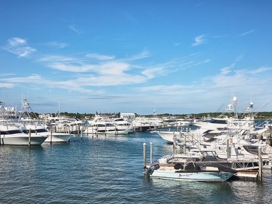 A marina with multiple yachts docked at the pier.