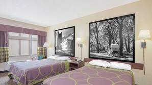 A hotel room with two beds, a window with curtains, a chair, and two wall-mounted lamps.