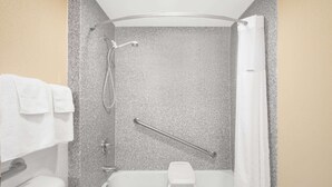 A bathroom with a bathtub, a shower, and a toilet.