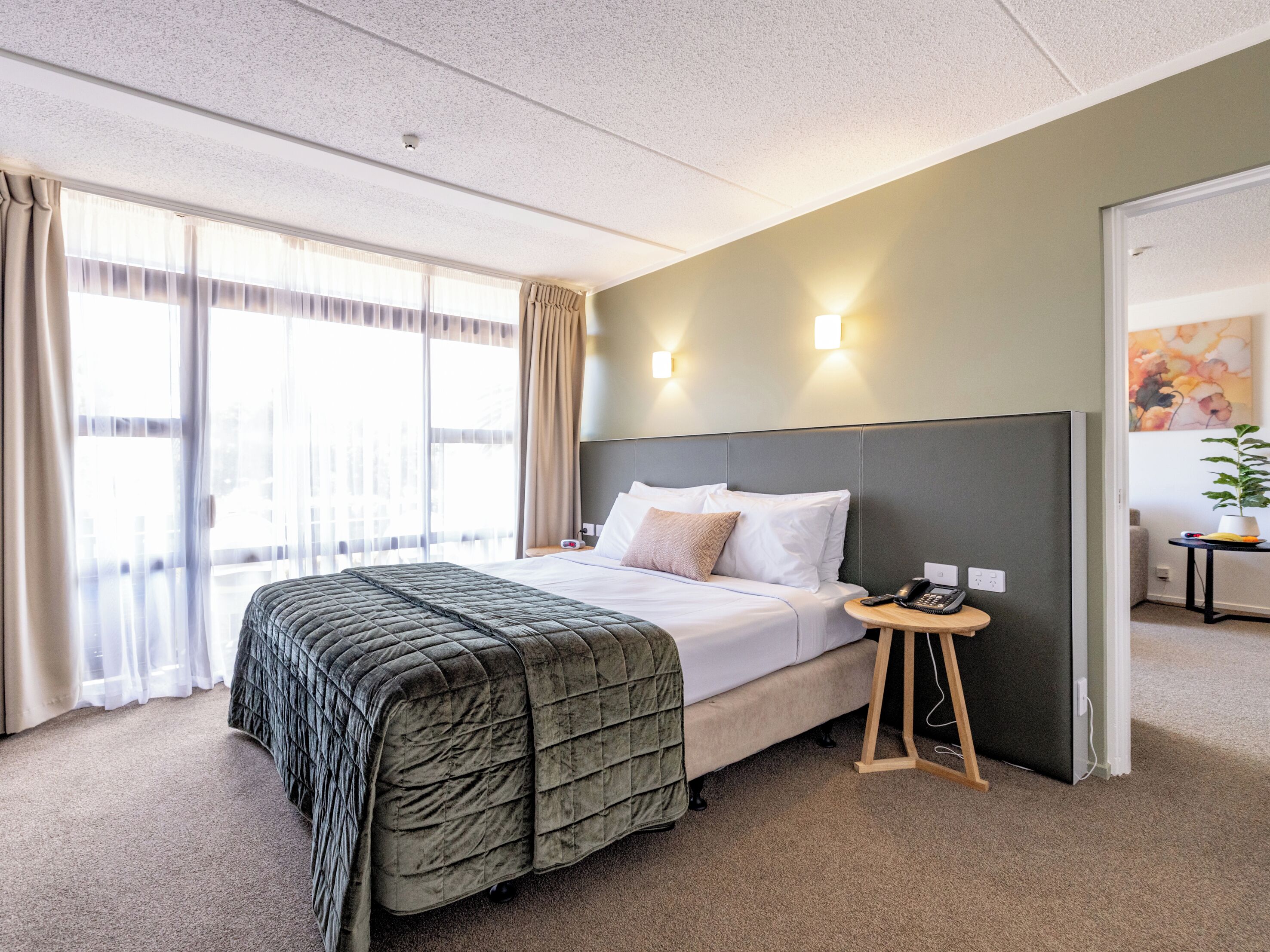 Junior King Suite with Lounge | Desk, laptop workspace, blackout drapes, iron/ironing board