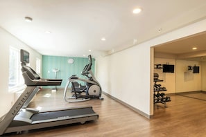 A home gym with a treadmill, elliptical, and dumbbells. - Holiday Inn Express Anaheim West by IHG (Anaheim)