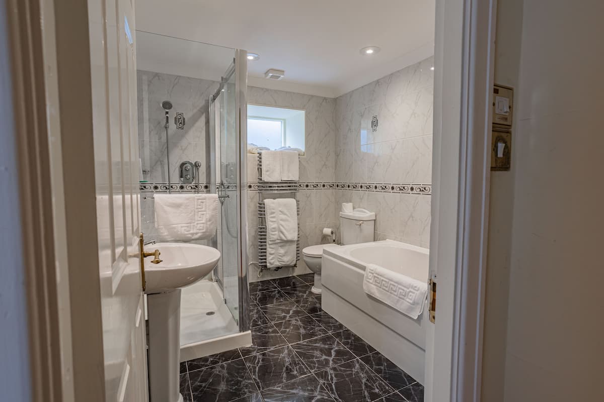 junior suite with outdoor seating | bathroom | combined shower/bathtub, hair dryer, towels