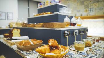 A breakfast buffet with various pastries and beverages.