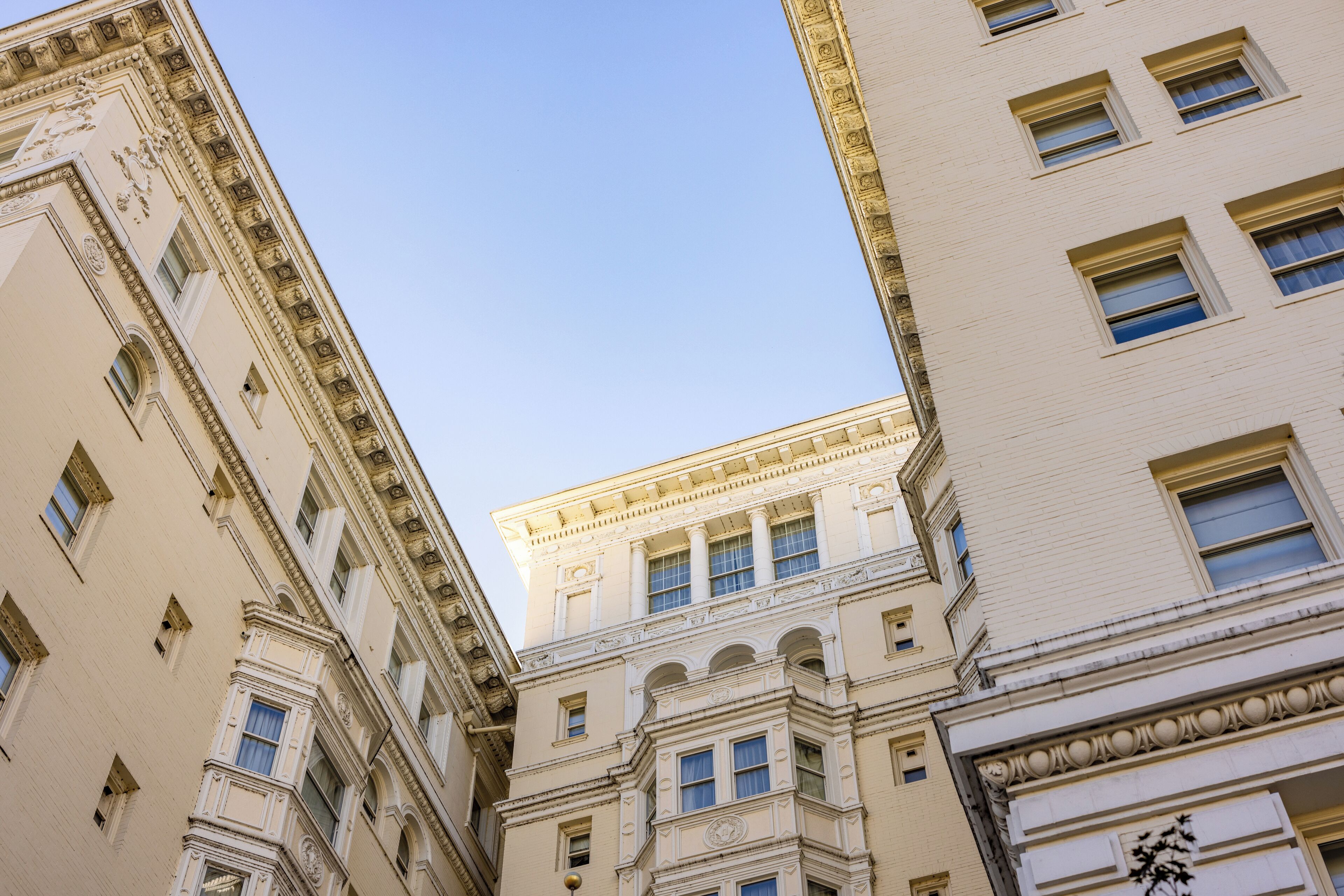 A multi-story building with classical architectural details, including ornate cornices and a symmetrical facade.