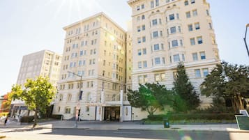 A large, multi-story building with a classic architectural style, featuring a prominent entrance and flagpole.