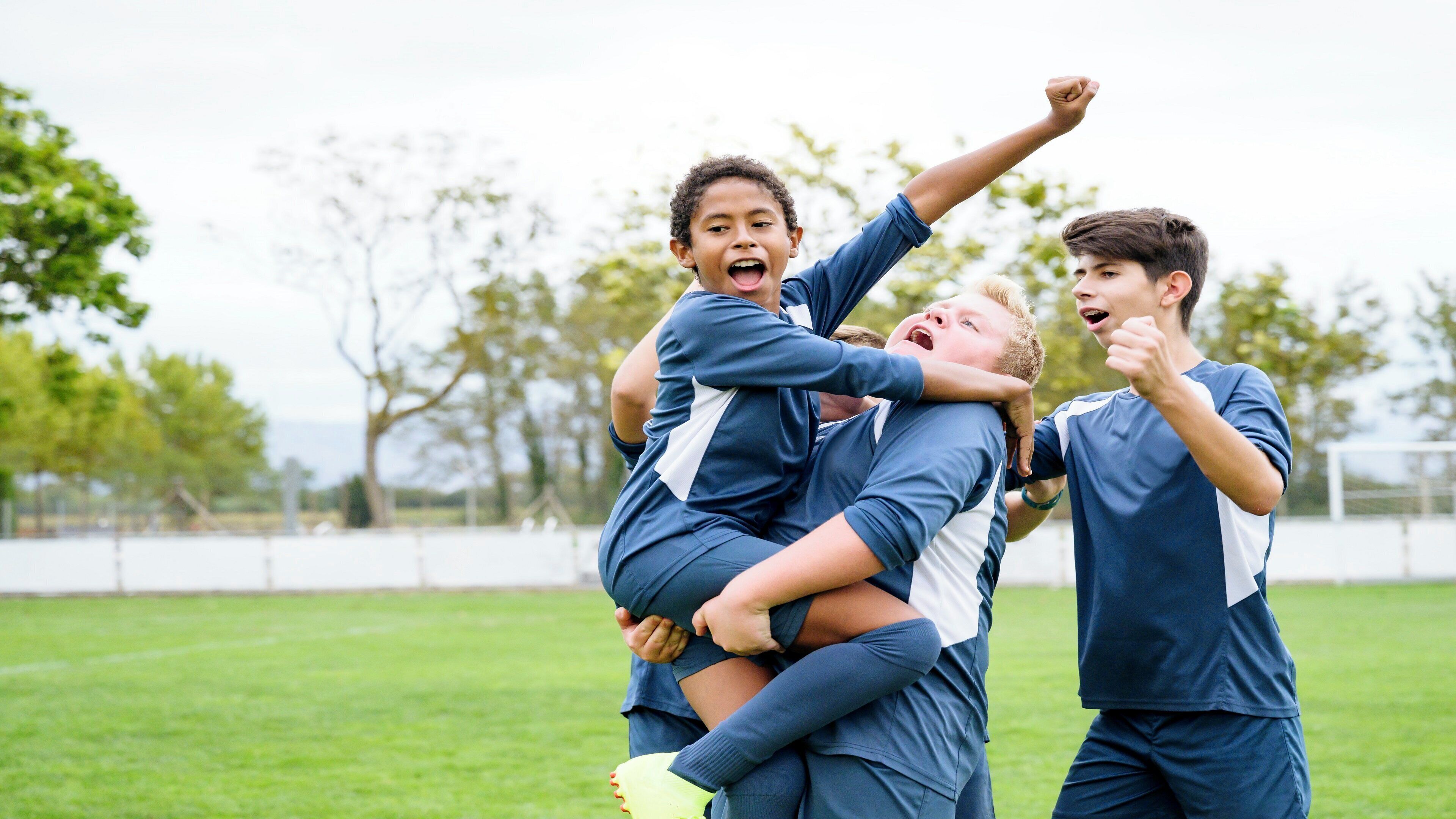 A group of people in sports attire on a grassy field.