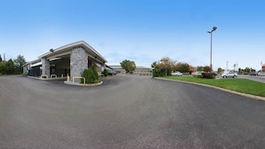 A building with a covered parking area and a clear sky.