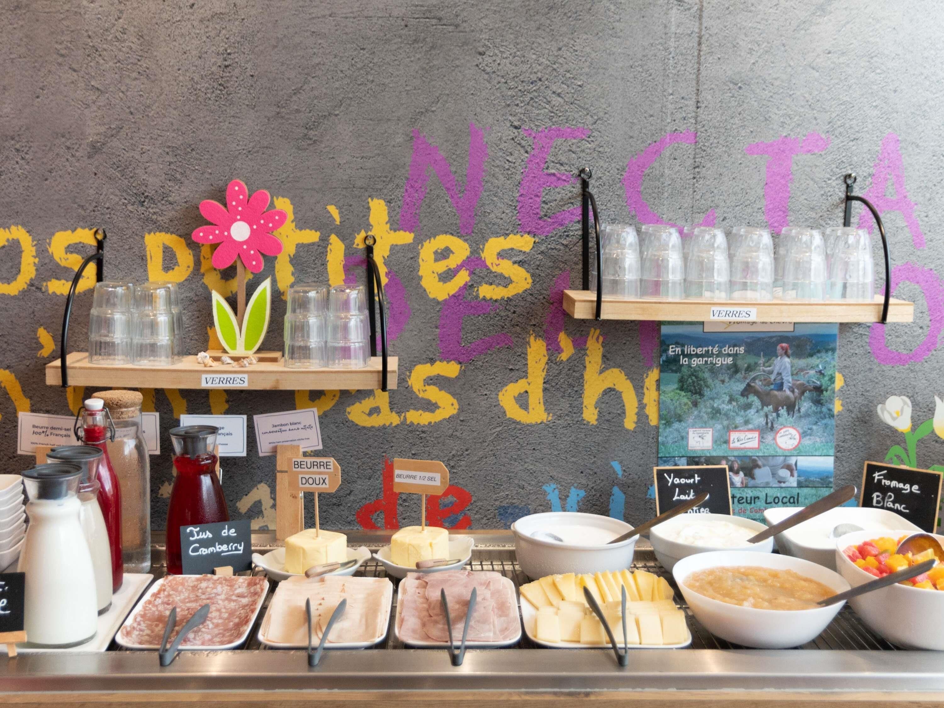 A breakfast buffet with various food items and drinks.