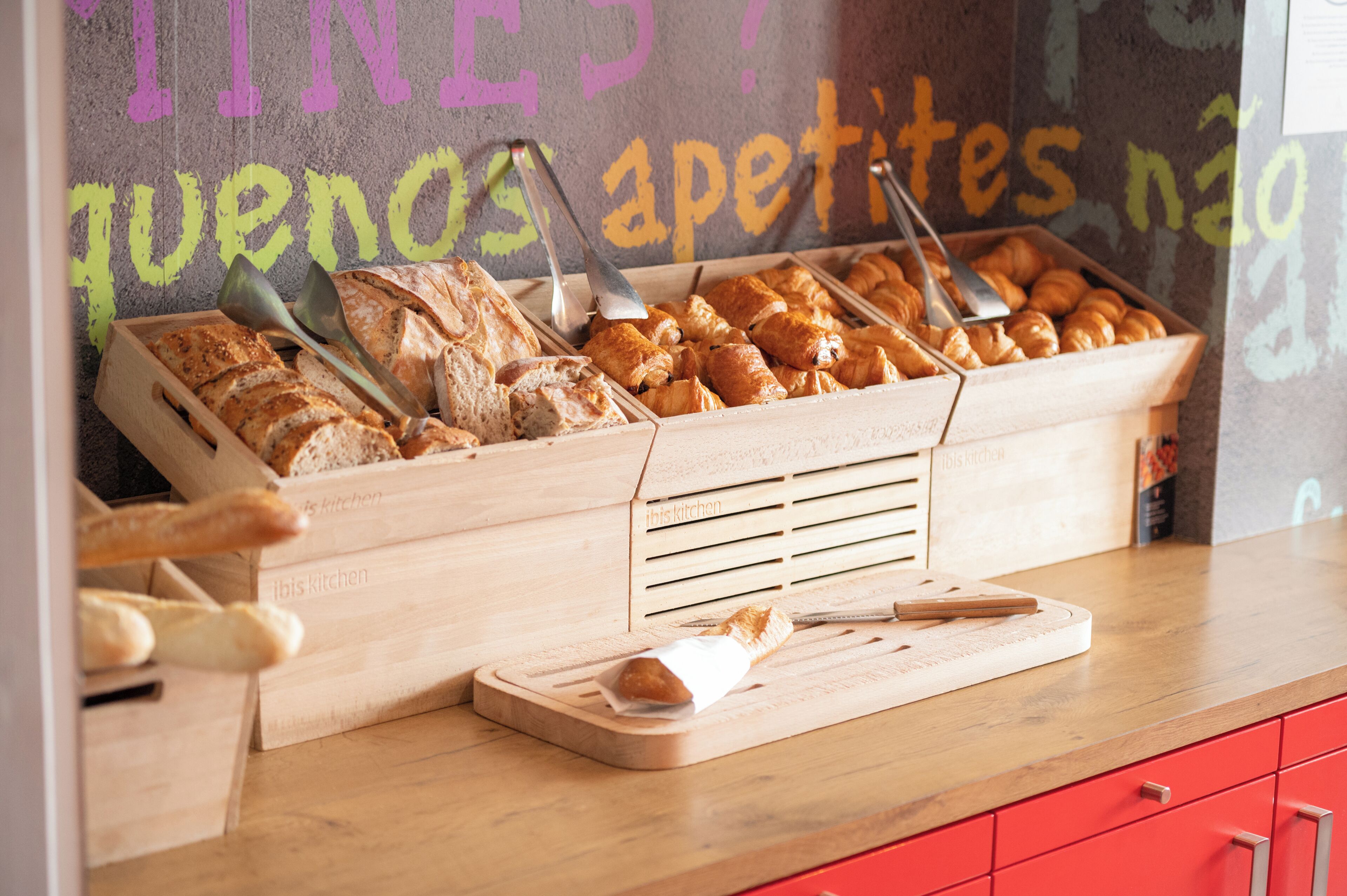 A bakery display with various breads and pastries.