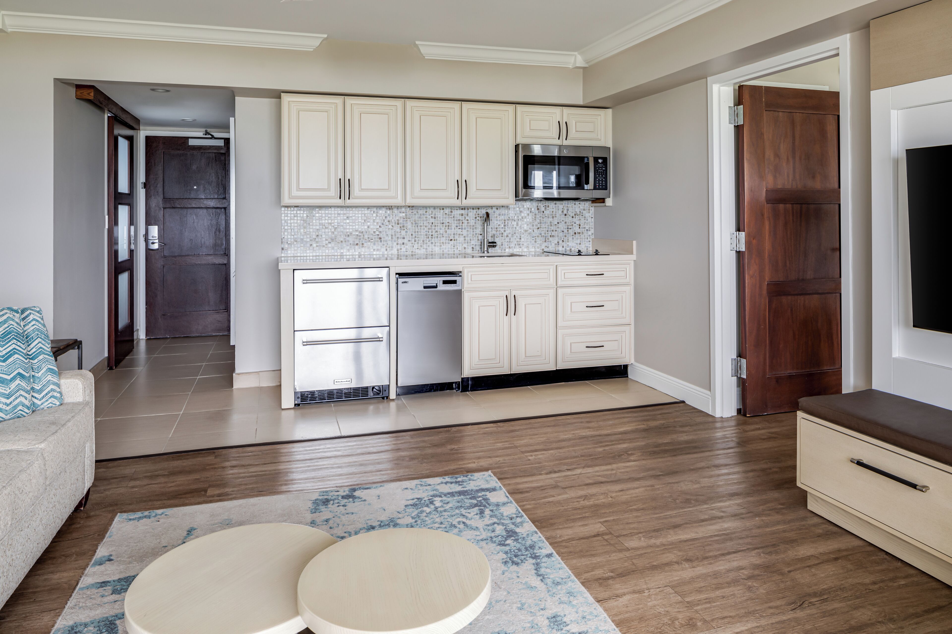 A modern kitchen with white cabinetry, a microwave, and a dishwasher.
