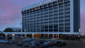 A multi-story building with a sign reading 'CROWNE PLAZA'. - Crowne Plaza San Antonio Airport by IHG (San Antonio)
